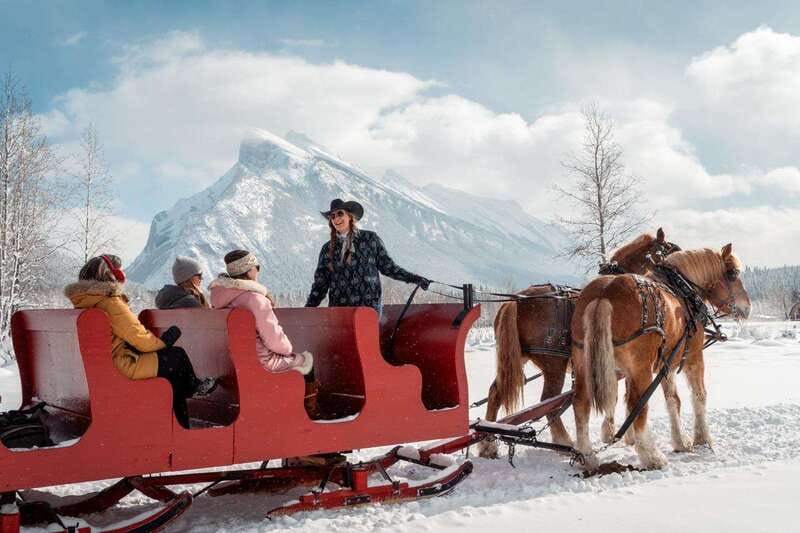 Banff: Family Friendly Horse-Drawn Sleigh Ride - Settling under wool blankets