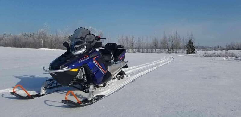 Quebec City: Guided Snowmobile Tour - Following the guide through woods and open stretches